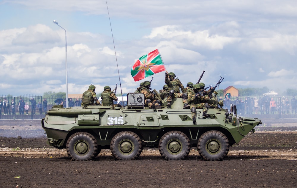 green and brown camouflage military tank