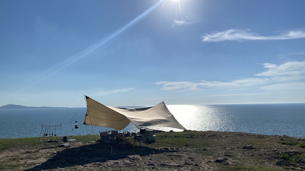 A spacious jgolf tent set up outdoors during a sunny day.