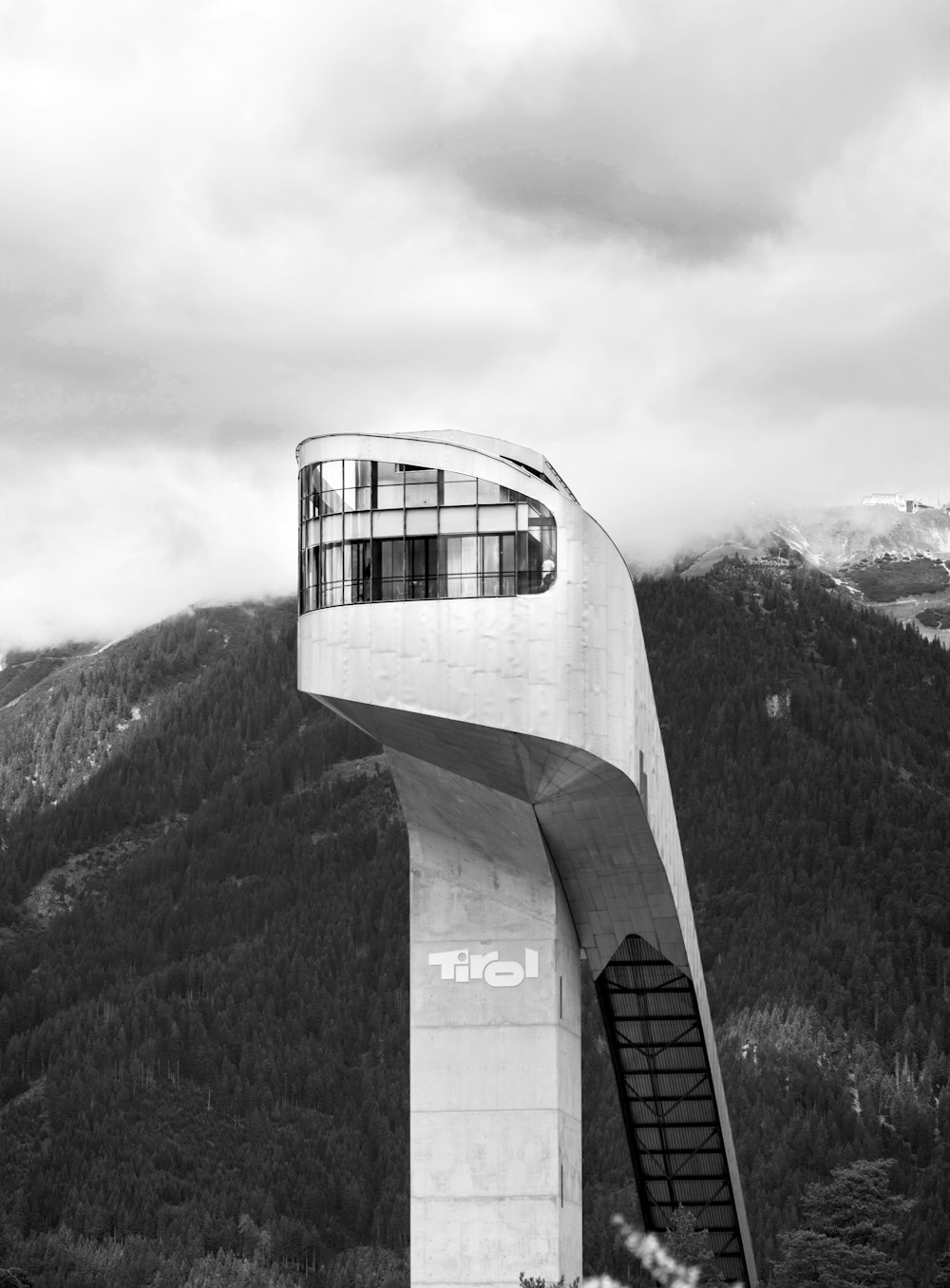 grayscale photo of building on top of mountain