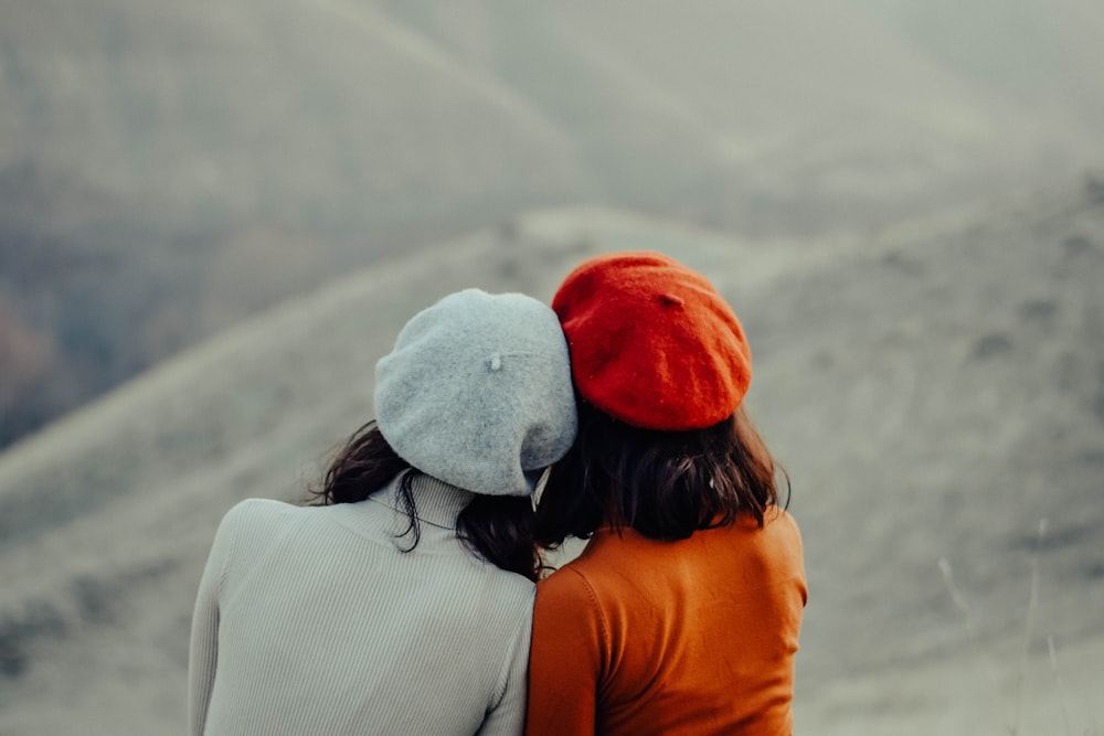 woman in white knit cap and orange shirt