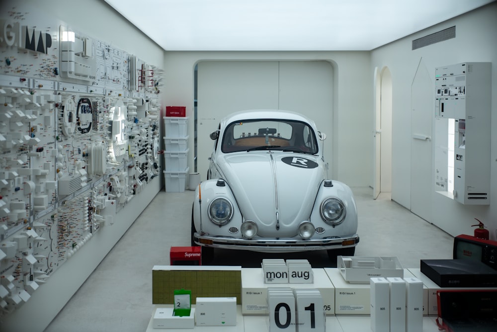 silver volkswagen beetle parked in building