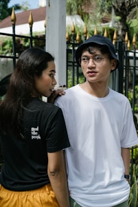 woman in white crew neck t-shirt wearing black cap