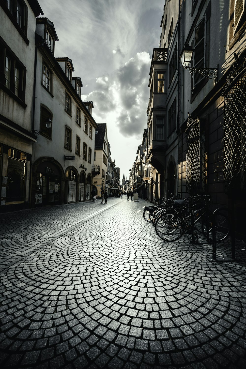 black bicycle parked beside brown concrete building during daytime