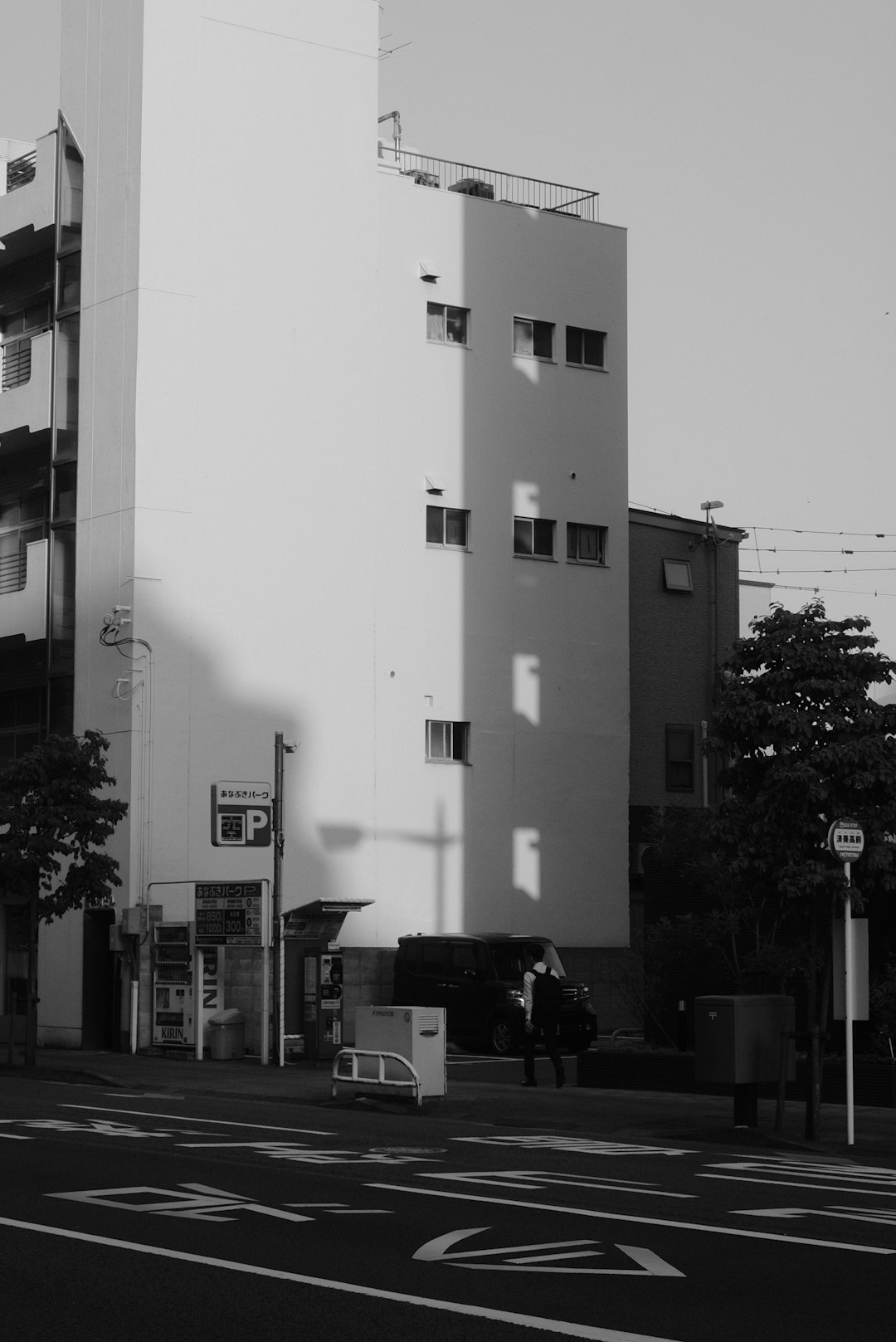 grayscale photo of building near trees