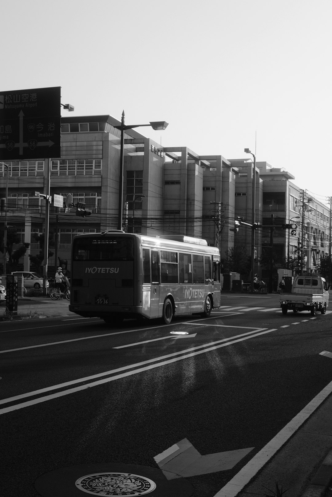 grayscale photo of bus on road