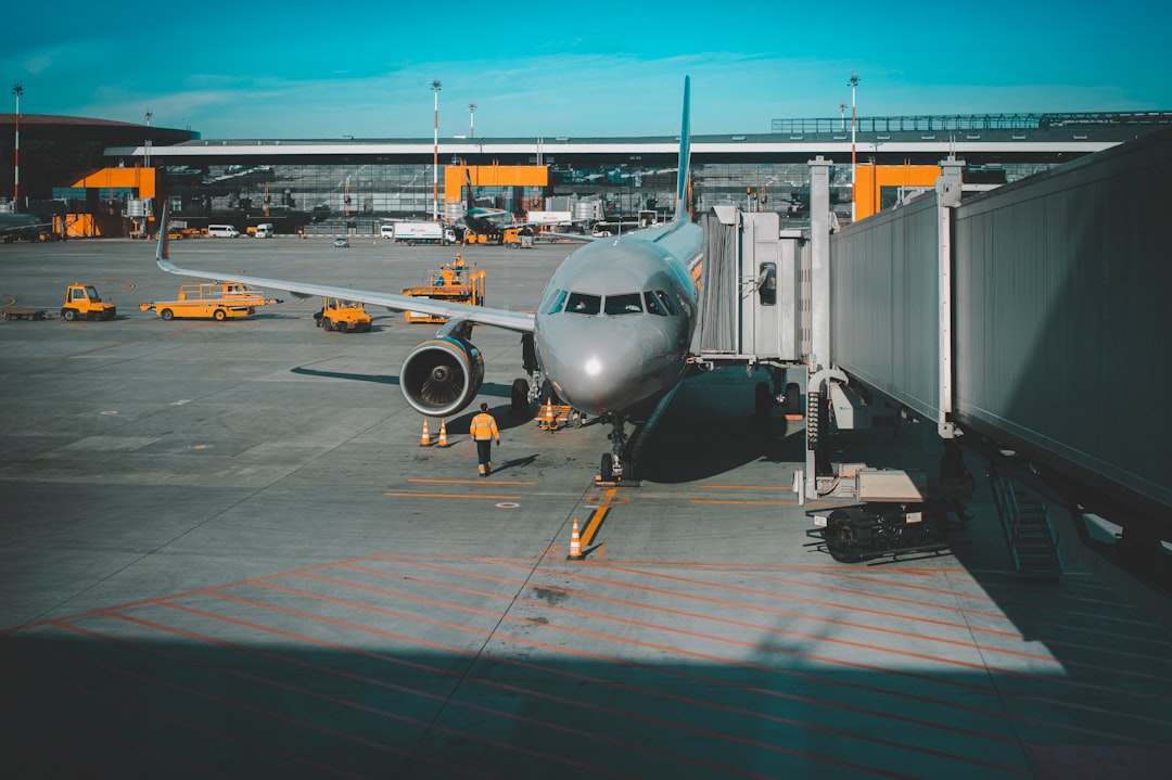 white airplane on airport during daytime