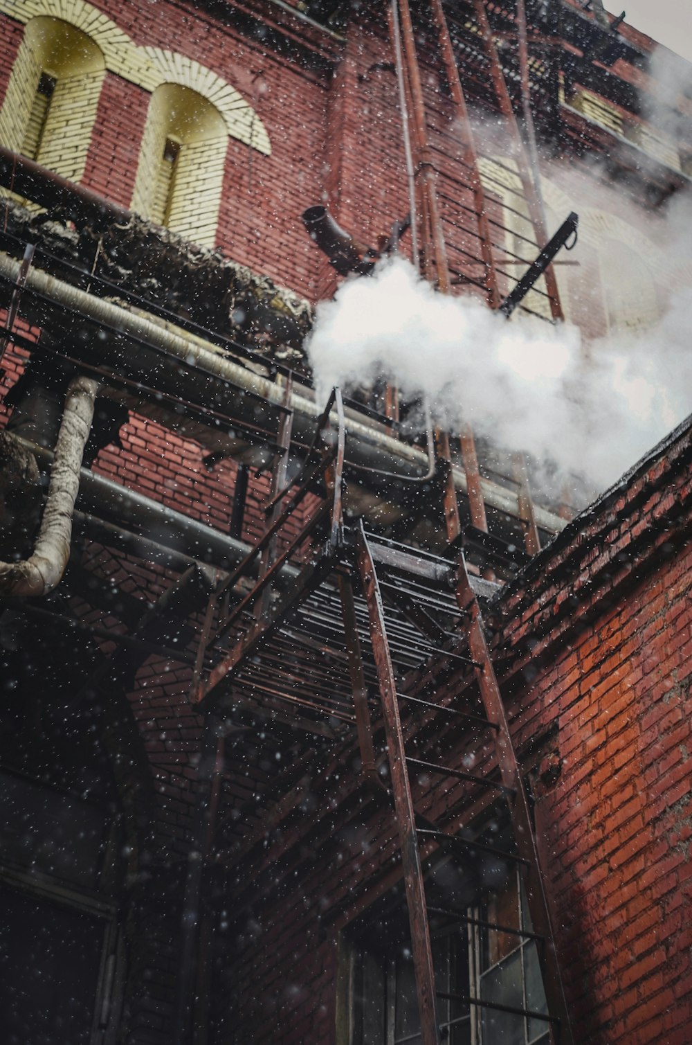 brown brick building with smoke