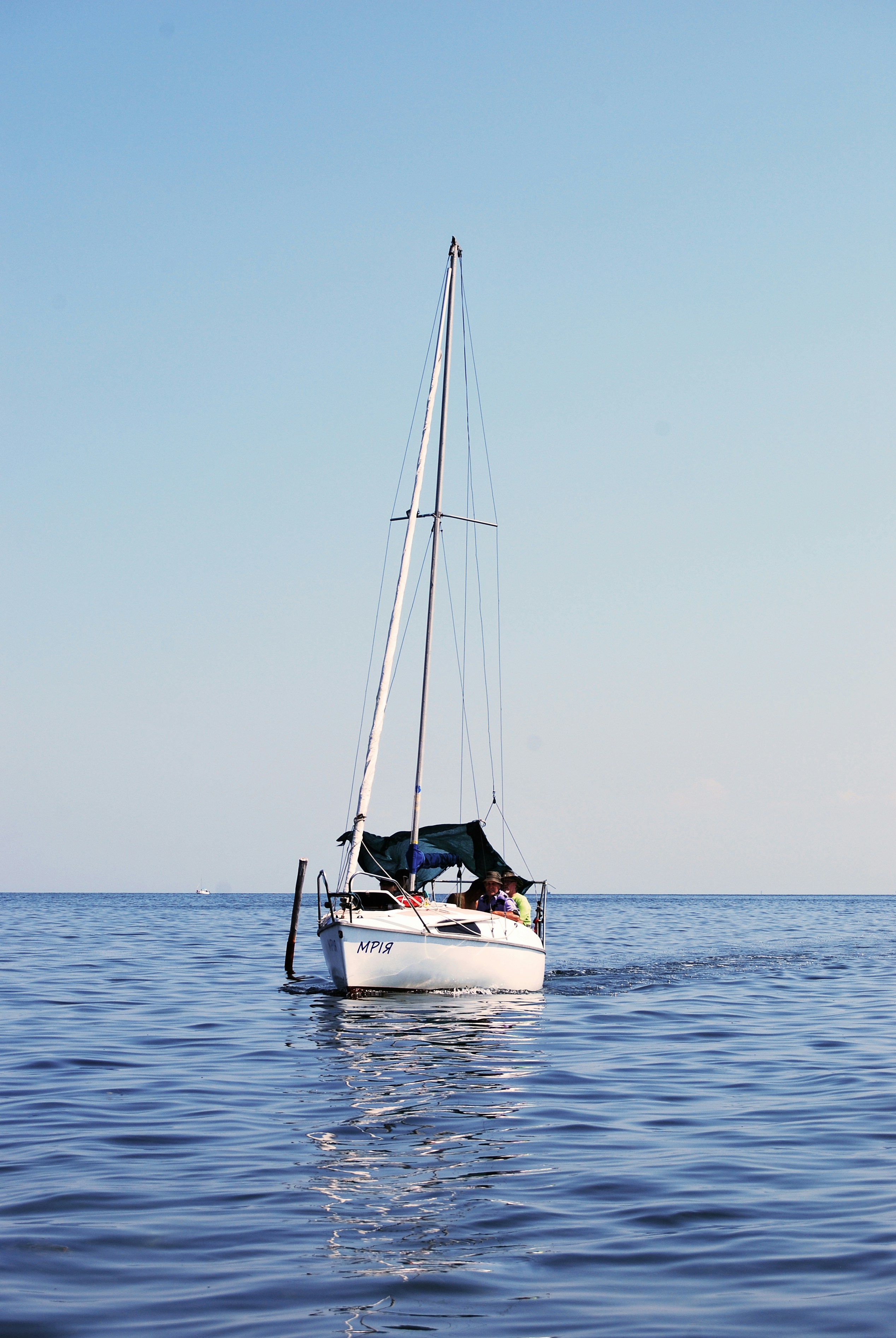 white and blue boat on sea during daytime