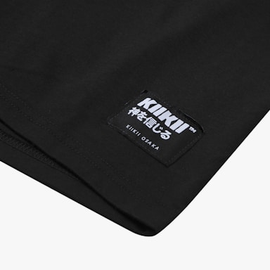 A black fabric with a label featuring white lettering. The label includes both English and Japanese characters with branding details.