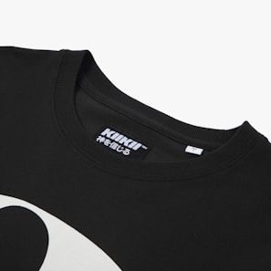 A close-up view of a black t-shirt featuring a neckline and a tag with the brand 'KIKII' printed on it, along with some Japanese characters. Part of a white graphic design is visible on the shirt's fabric.