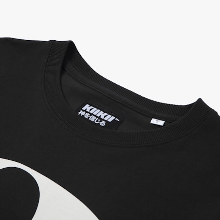 A close-up view of a black t-shirt featuring a neckline and a tag with the brand 'KIKII' printed on it, along with some Japanese characters. Part of a white graphic design is visible on the shirt's fabric.