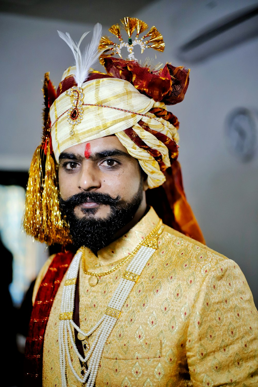 man in yellow and red floral dress