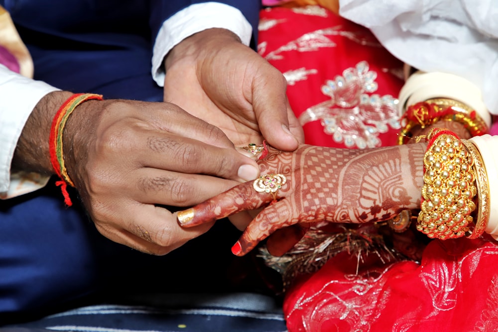 person with red and white manicure