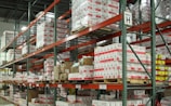 white and red cardboard boxes on shelf