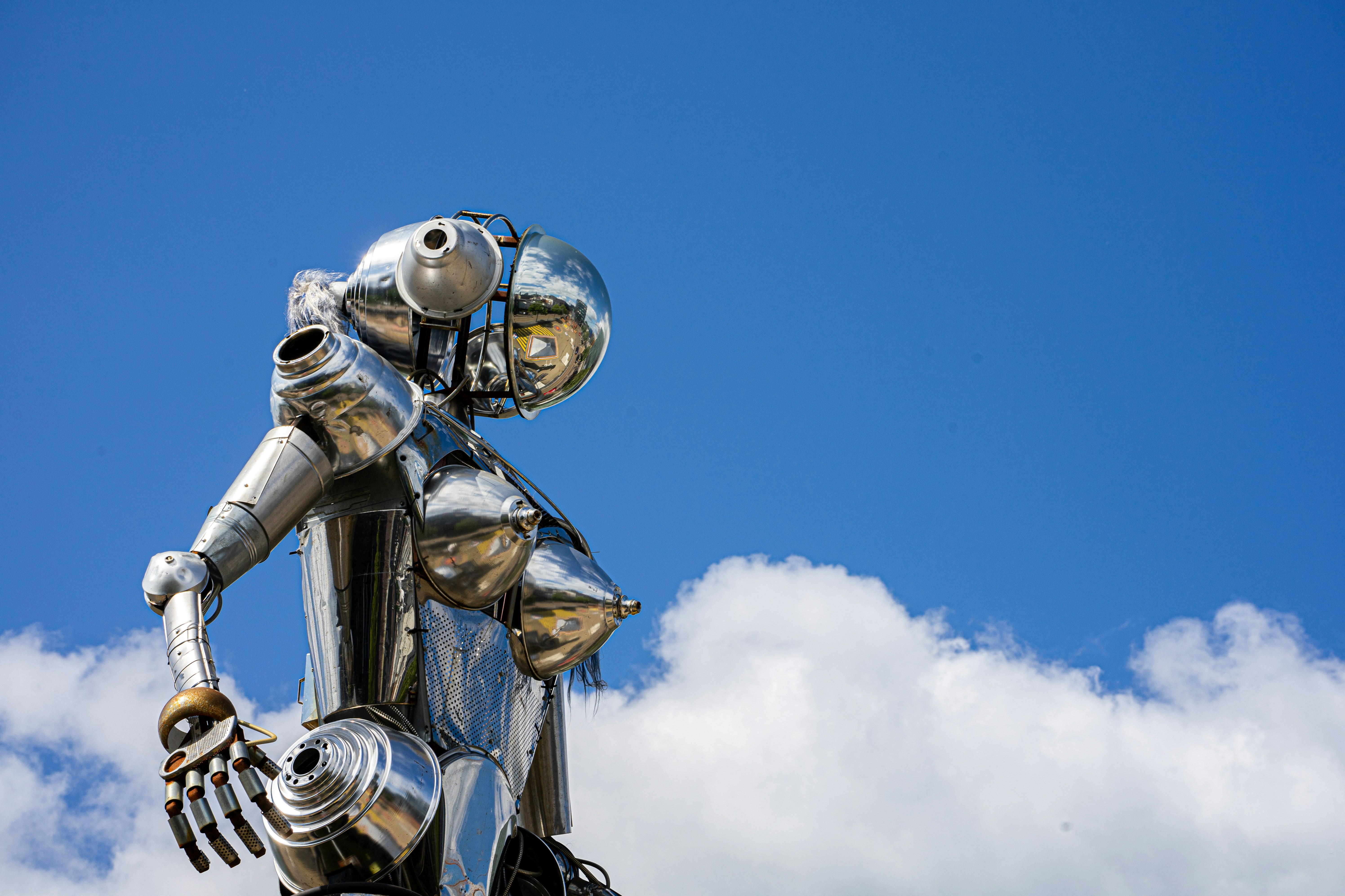 Branimo gold robot statue under blue sky during daytime