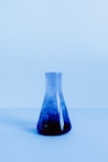 blue tinted glass bottle with blue liquid