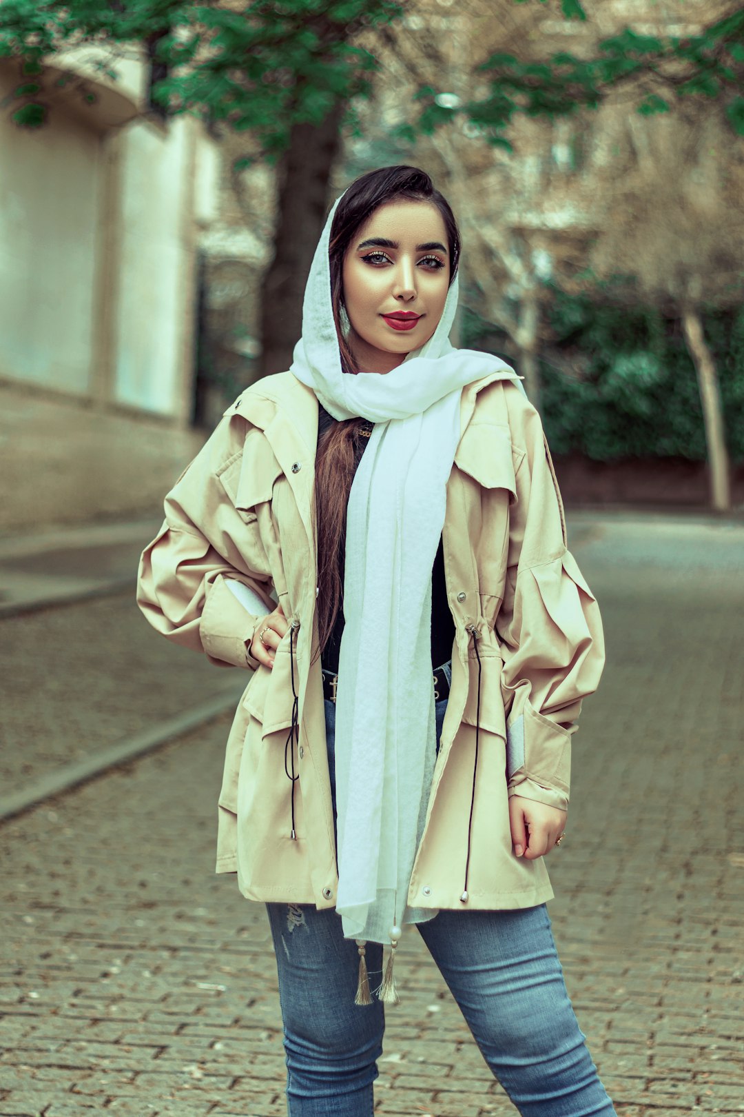 woman in brown coat standing on brown concrete pathway during daytime