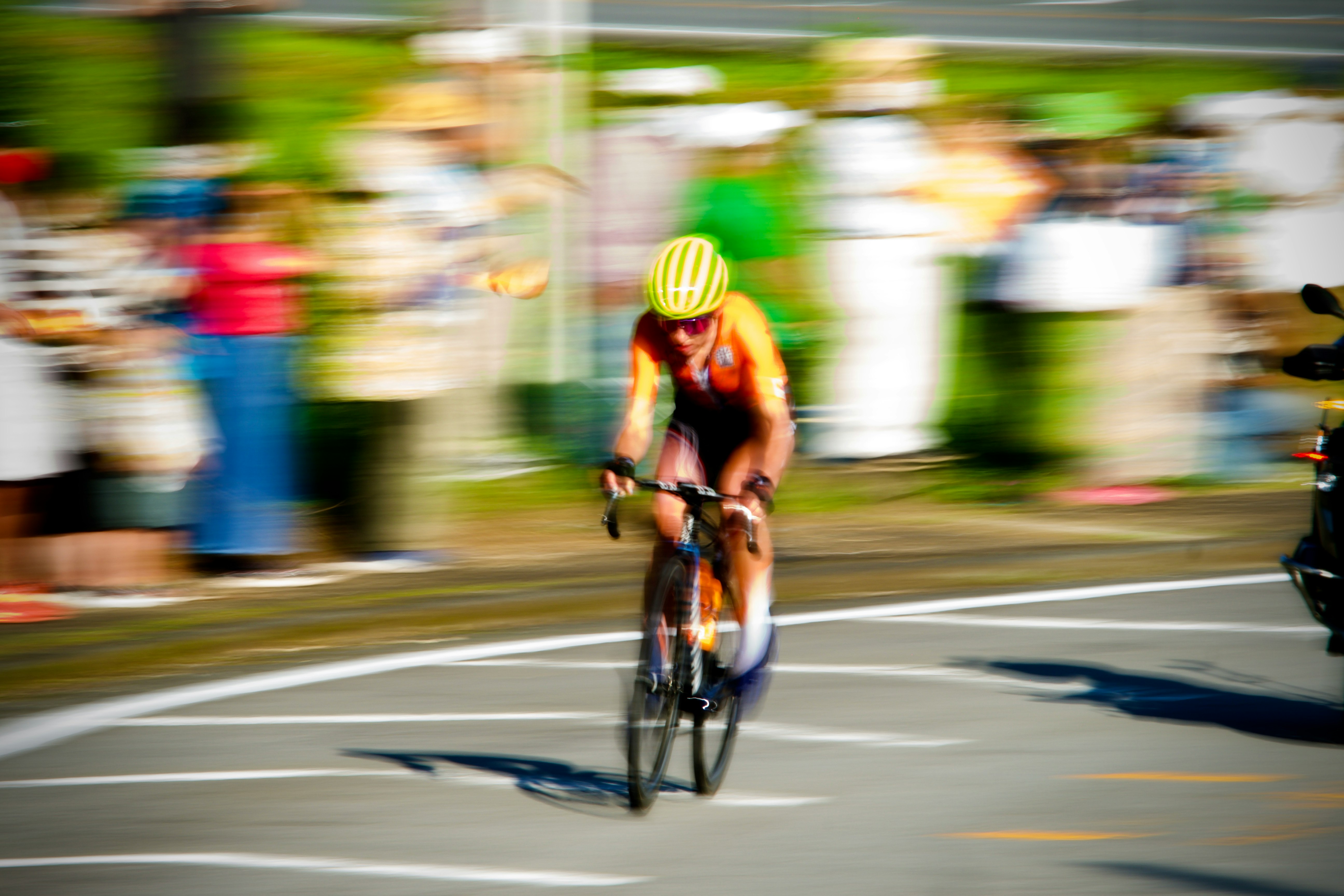 man in green shirt riding on bicycle during daytime