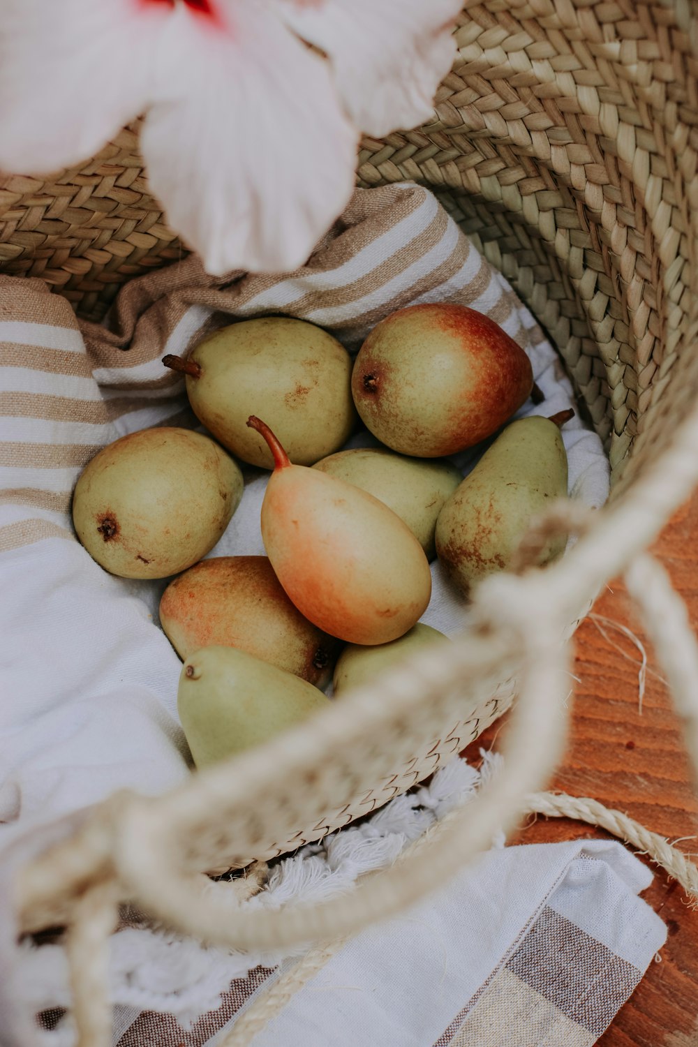 a basket filled with pears on top of a table