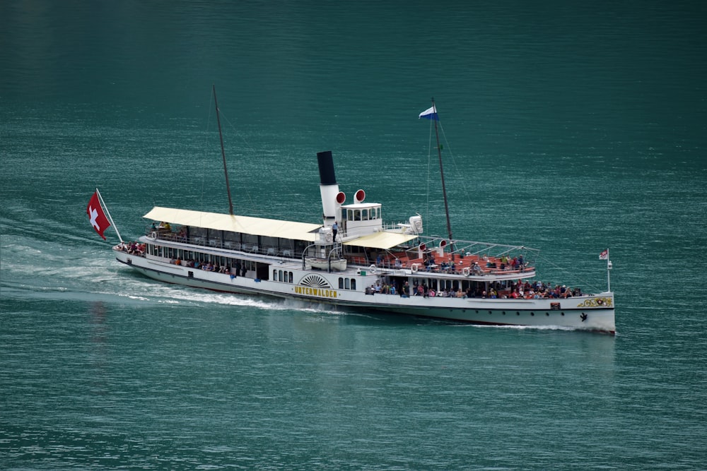 white and blue ship on sea during daytime