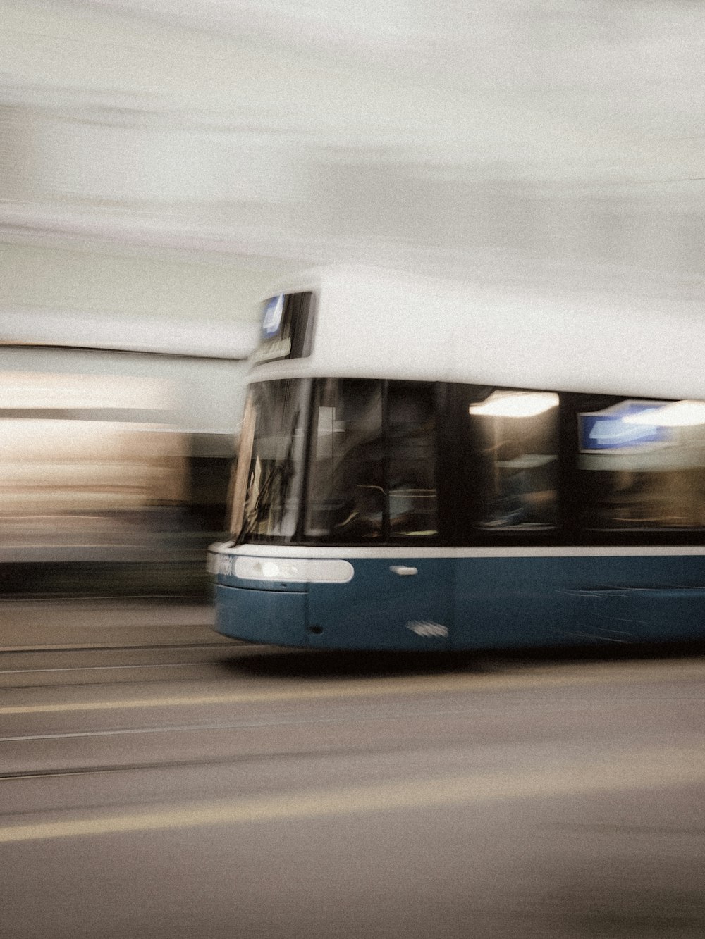 white and blue train on road during daytime