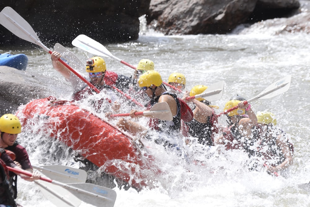 a group of people riding on top of a raft down a river
