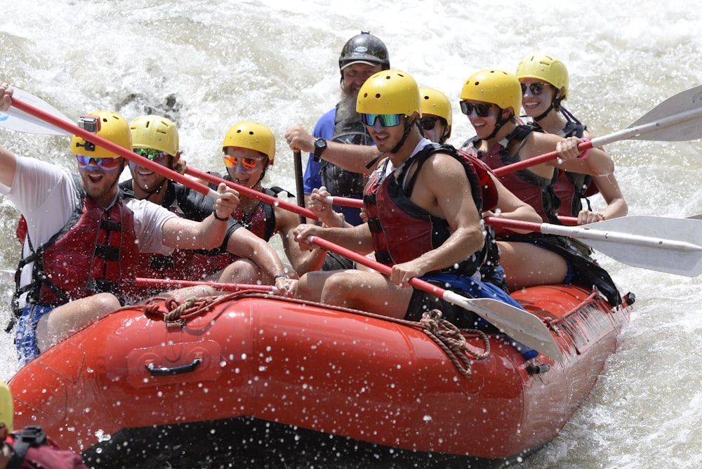 a group of people riding on top of a raft