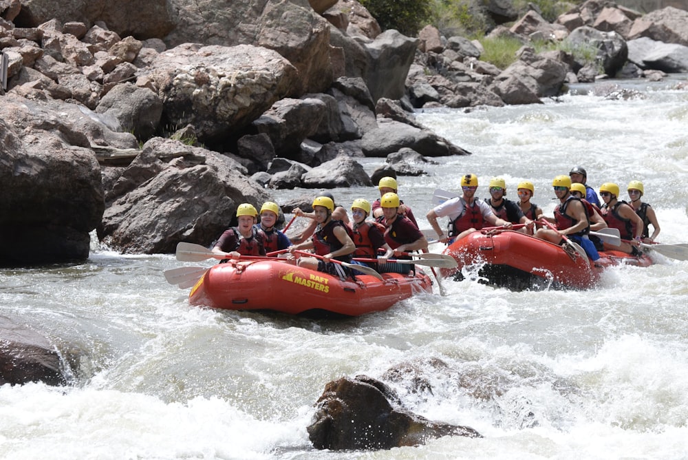 a group of people riding rafts down a river