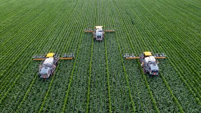 yellow and black heavy equipment on green field during daytime