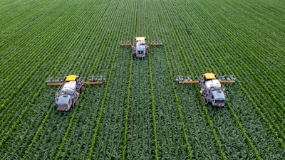 Rows of shiny agricultural machinery ready for use in the field.