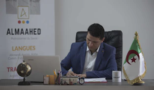 man in blue suit jacket sitting on black office rolling chair