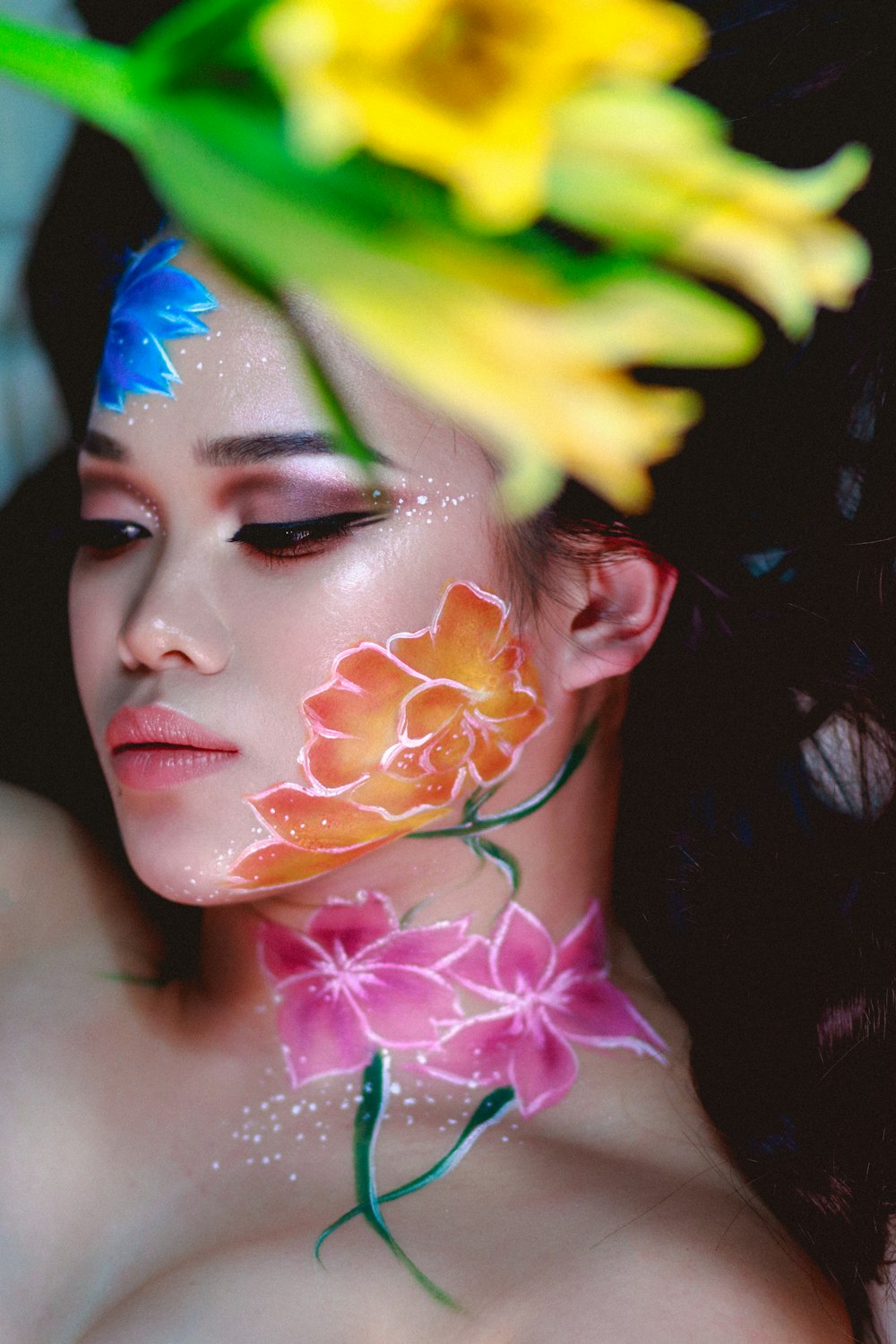 woman with yellow green and blue face paint