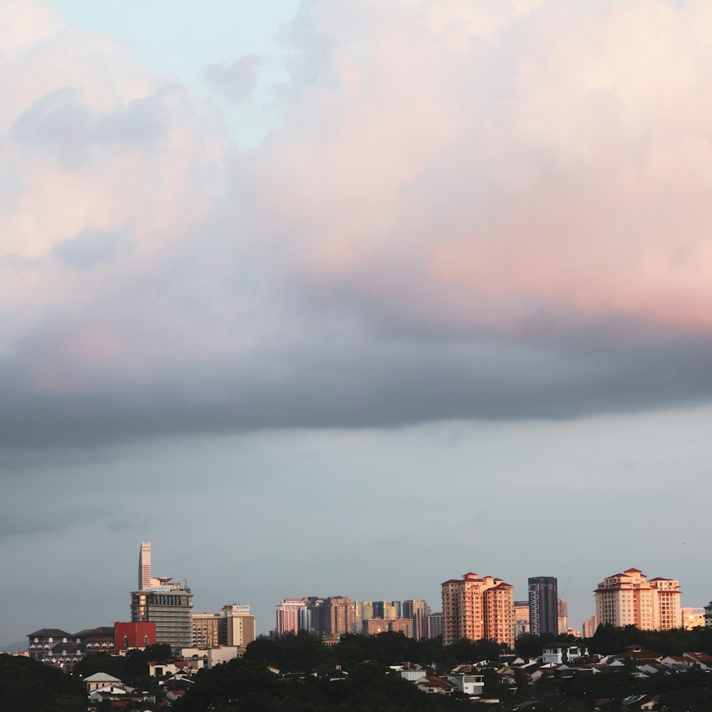 city skyline under white clouds during daytime