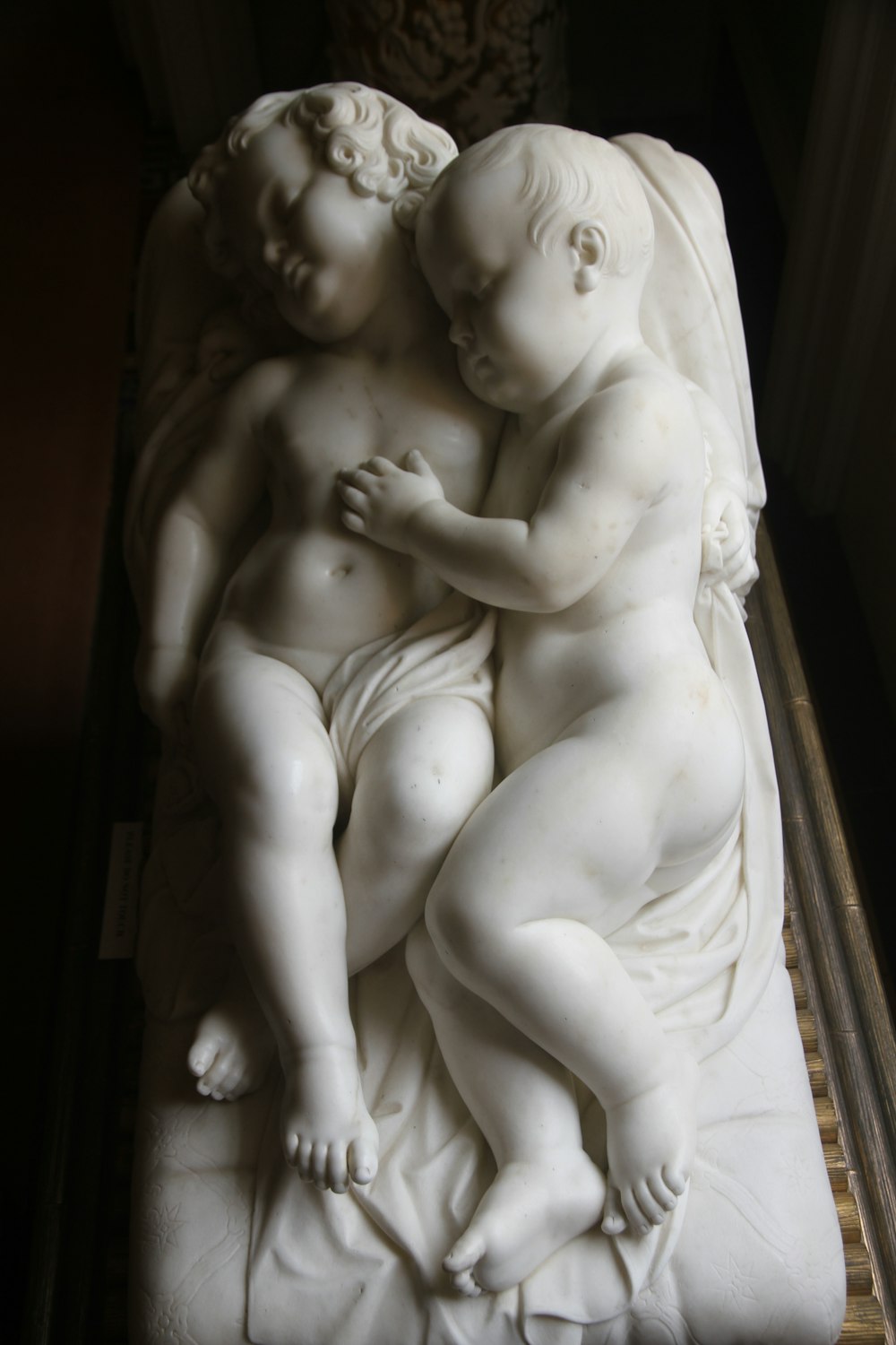 naked woman carrying baby statue