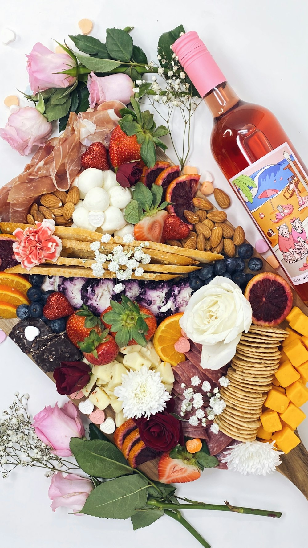 a bottle of wine sitting next to a bunch of food