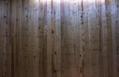 Detailed shot of technical drawings pinned on a wall.