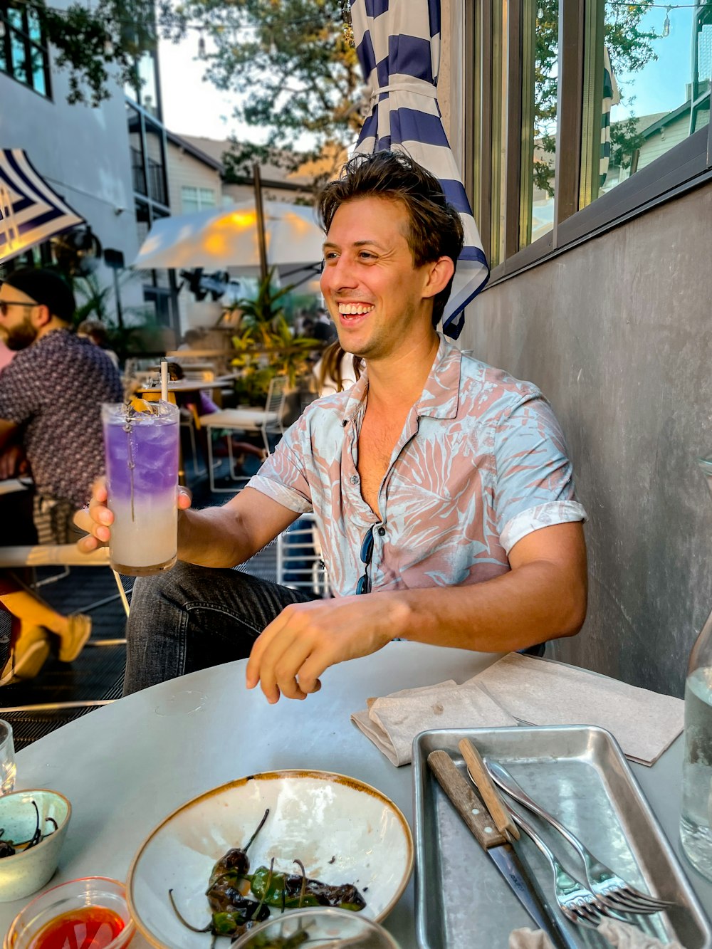 woman in white and pink stripe button up shirt holding ice cream