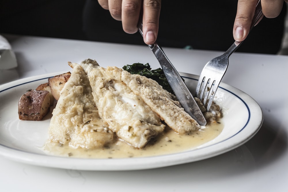 stainless steel fork on white ceramic plate