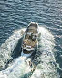 man in blue shorts on white and brown boat during daytime