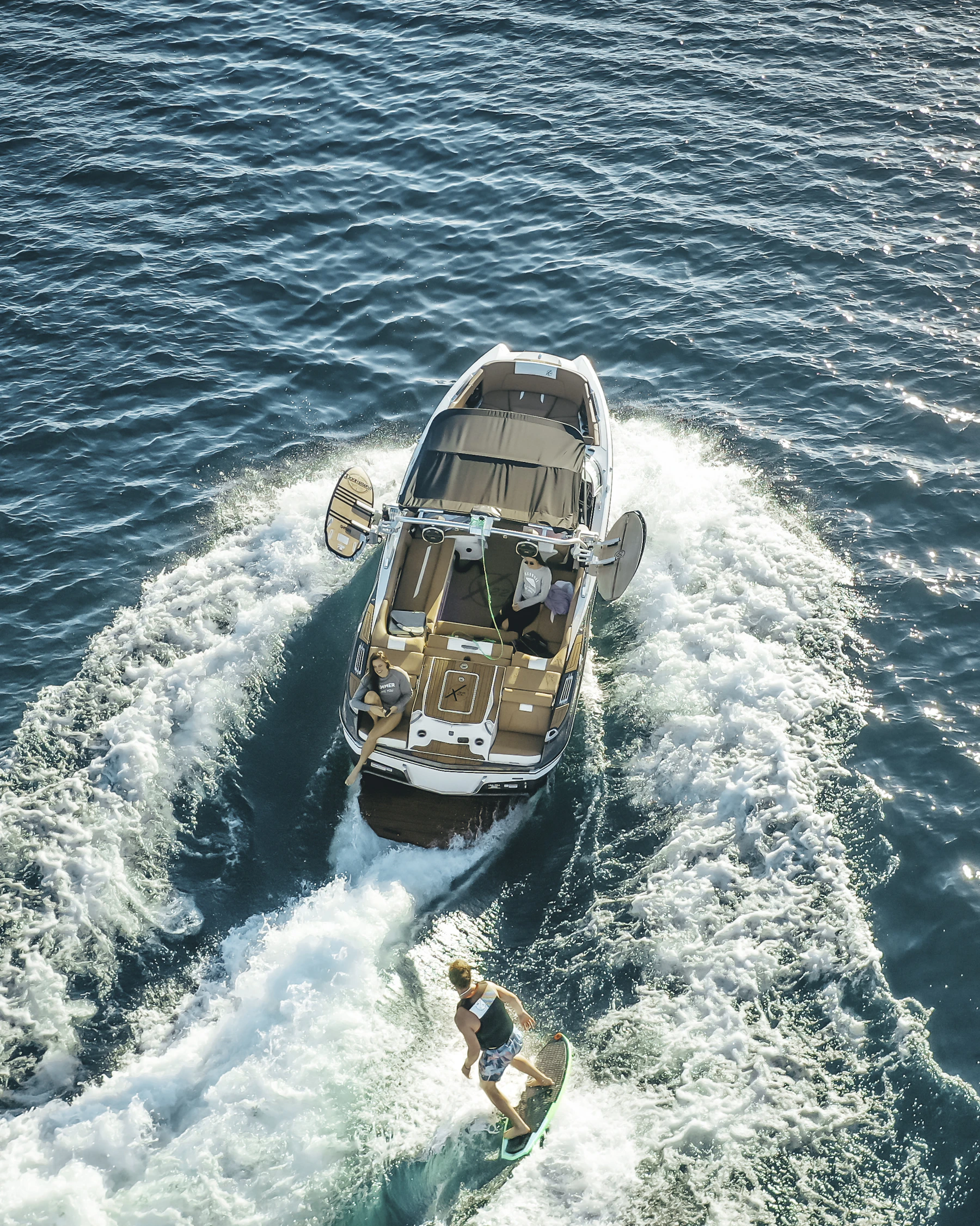 Wake surfing behind a recreational boat