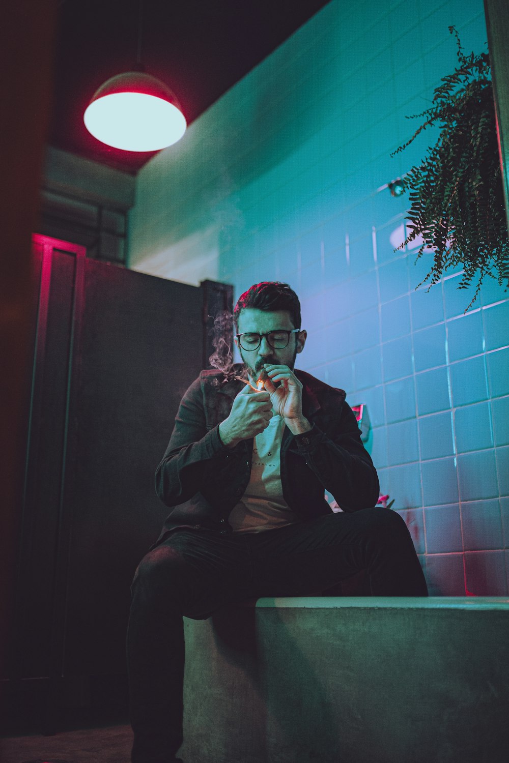 man in black suit jacket smoking cigarette