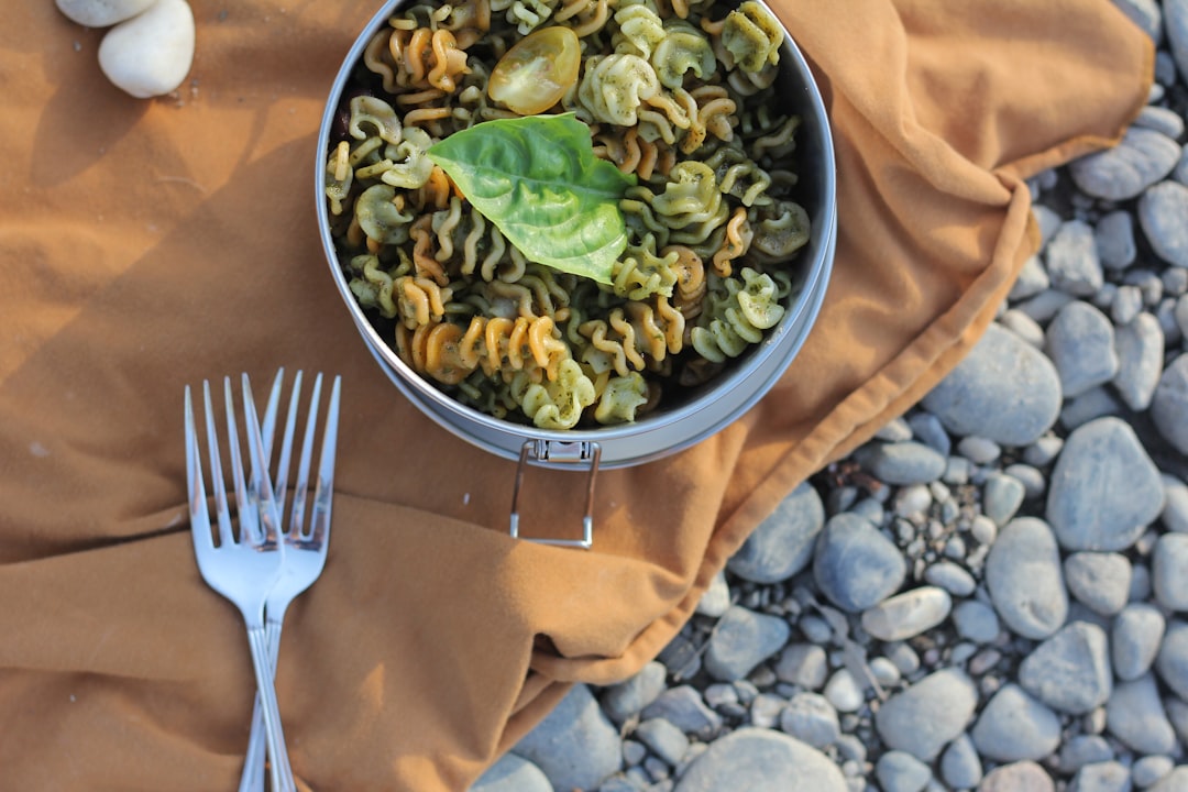 stainless steel fork beside bowl of green vegetable salad