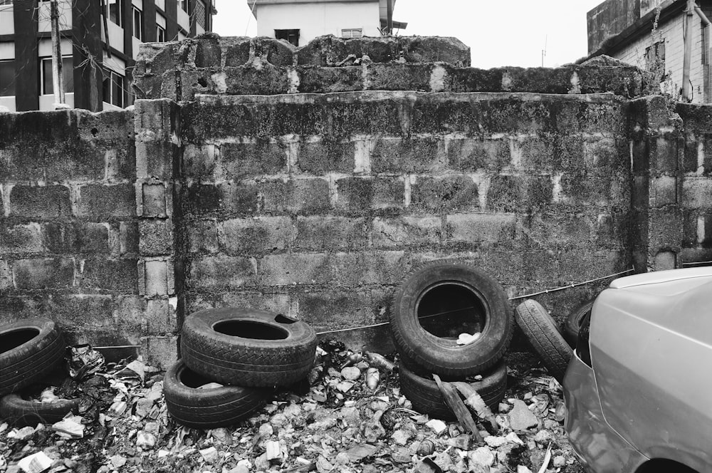 black car tire on gray concrete wall