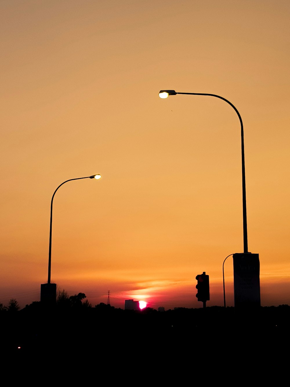 black street light during sunset