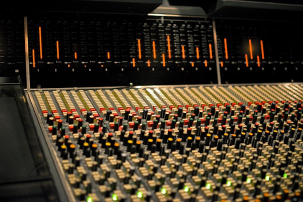 Modern mixing console with colorful LED lights in a professional studio