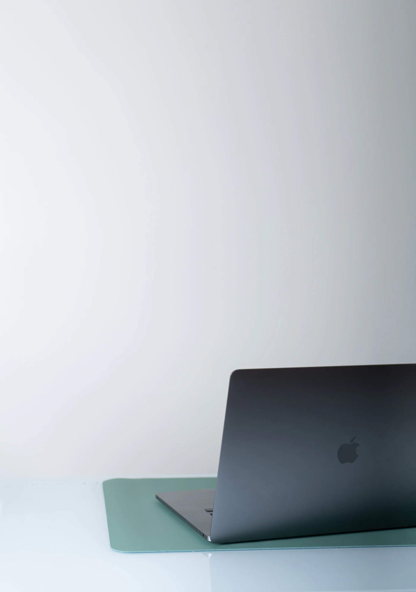 A MacBook on a clean grey desk