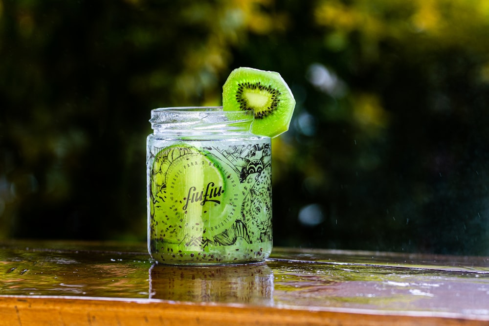 green and white labeled glass jar