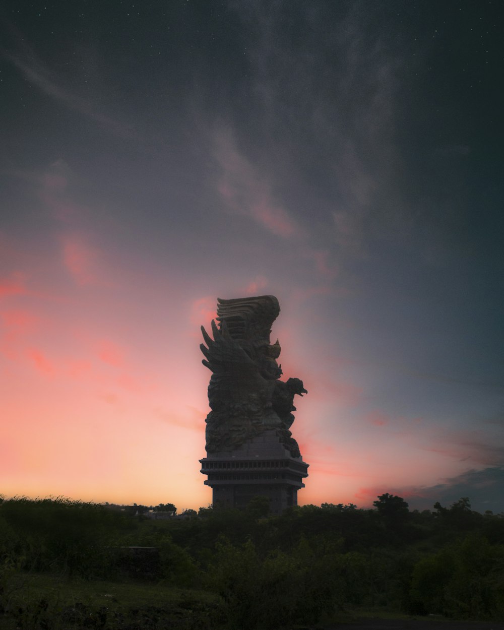 Estatua de hormigón negro durante la puesta de sol