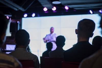 An engaging audience watching an immersive multimedia presentation in a modern setting.