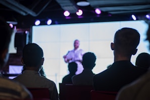 Close-up of a speaker answering questions during a Q&A session with bright conference branding.